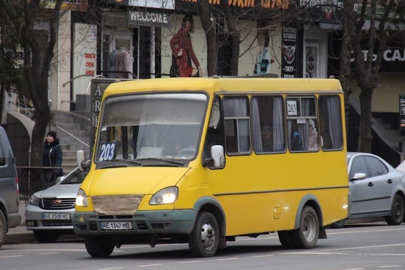 Жовта маршрутка з номером 203 на лобовому склі їде вулицею Кривого Рогу