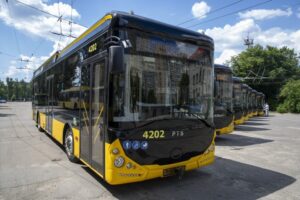 Сучасний тролейбус чорно-жовтого кольору на стоянці